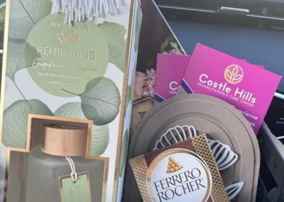 Product display of fragrance and beauty items with branded packaging.