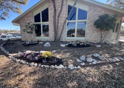 Front entrance of Castle Hills with landscaped flower beds and parking area