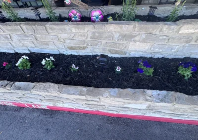 Landscaped flower bed with colorful flowers and decorative edging.